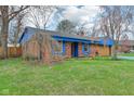 Charming brick home with well-maintained lawn and mature trees at 1422 N Trillium Ct, Indianapolis, IN 46219