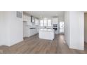 Modern kitchen with stainless steel appliances, center island, and bright white cabinets at 14532 Hanford Ln, Carmel, IN 46074