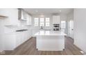 Modern kitchen with stainless steel appliances, center island, and bright white cabinets at 14532 Hanford Ln, Carmel, IN 46074