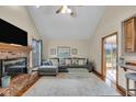 Cozy living room with a brick fireplace, vaulted ceilings, and a comfortable gray sectional sofa at 1598 Thornburg Ln, Franklin, IN 46131