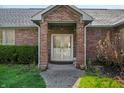 Inviting front entrance featuring classic brickwork, a covered porch, and a traditional double door at 1791 S Conservation Club Rd, Morgantown, IN 46160