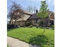 Well-maintained home with lush green lawn and mature trees at 1813 Birch Dr, Plainfield, IN 46168