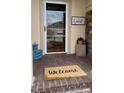 Cozy porch with a 'Welcome' mat and decorative accents at 1813 Birch Dr, Plainfield, IN 46168