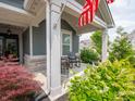Inviting covered front porch with seating area and charming details with colorful plantings at 1972 Mobley Dr, Westfield, IN 46074