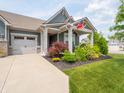 Charming home featuring a covered porch, beautiful landscaping, and an inviting walkway at 1972 Mobley Dr, Westfield, IN 46074