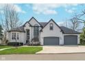 Traditional two-story home with a three-car garage and freshly mowed lawn in a suburban neighborhood on a clear day at 219 Surrey Hill, Noblesville, IN 46062