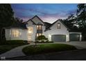 Charming two-story white brick home with a well-manicured lawn and professional landscaping during a beautiful sunset at 219 Surrey Hill, Noblesville, IN 46062