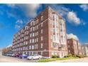 Brick apartment building featuring beautiful window frames and on-site parking at 230 E 9Th St # 502, Indianapolis, IN 46204