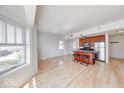 Sun-filled living space with hardwood floors and a modern kitchen island at 230 E 9Th St # 502, Indianapolis, IN 46204