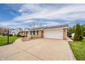 Spacious ranch home with a long, wide driveway leading to an attached two-car garage at 2511 Ritter Dr, Anderson, IN 46012
