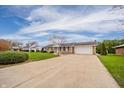 Single-story home featuring a long driveway and a well-maintained front yard with landscaping at 2511 Ritter Dr, Anderson, IN 46012