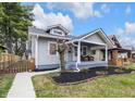 Charming home featuring a welcoming front porch with seating and well-maintained landscaping at 2737 Napoleon St, Indianapolis, IN 46203