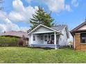 Charming home featuring a welcoming front porch with seating and well-maintained landscaping at 2737 Napoleon St, Indianapolis, IN 46203