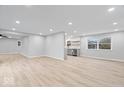 Open-concept living room showcasing luxury vinyl plank floors and neutral walls, offering a bright, airy space at 322 S Boehning St, Indianapolis, IN 46219
