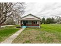 Quaint single-story home with a cozy front porch and a well-maintained lawn at 359 N Whitcomb Ave, Indianapolis, IN 46224