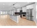 Modern kitchen featuring stainless steel appliances, two-tone cabinetry, and center island at 401 Iowa St, Indianapolis, IN 46225