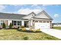 Charming home with stone accents, manicured lawn, and a two-car garage, blending curb appeal with functionality at 4179 Hume Ave, Plainfield, IN 46168