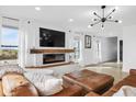 Bright living room with a modern fireplace, recessed lighting, and a comfortable leather couch at 431 W Main St, Lizton, IN 46149