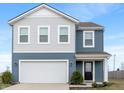Charming two-story home with blue and gray siding, white trim, and attached two car garage at 432 Bluestem Ln, Whiteland, IN 46184