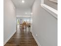 Hallway with wood floors leading to dining and living areas bathed in natural light at 432 Bluestem Ln, Whiteland, IN 46184