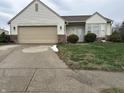 Inviting single-story home featuring vinyl siding, an attached garage, and tidy front yard at 4320 Lucky Ct, Indianapolis, IN 46203