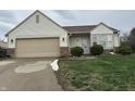 Inviting single-story home featuring vinyl siding, an attached garage, and tidy front yard at 4320 Lucky Ct, Indianapolis, IN 46203