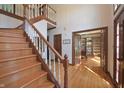 Elegant foyer with hardwood floors, staircase, and access to a private office at 5139 Kingswood Dr, Carmel, IN 46033