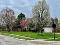 Charming brick home with attached garage and a beautifully landscaped front yard at 5139 Kingswood Dr, Carmel, IN 46033