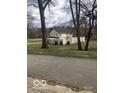 View of the rear of the home with a backyard and a partially finished privacy fence at 5657 E Fall Creek Pkwy N Dr, Indianapolis, IN 46226