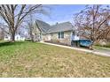 View of the home exterior featuring well-manicured lawn and inviting entrance at 6170 Shelbyville Rd, Indianapolis, IN 46237
