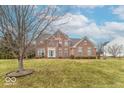 Two-story brick home featuring an inviting entrance and a well-manicured lawn at 6272 Turnbridge Dr, Avon, IN 46123