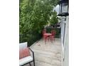 Charming balcony with red bistro set, greenery and black railing at 6379 Fairfield St, Whitestown, IN 46075