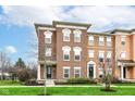 Charming brick townhome with manicured lawn and bright, sunny curb appeal at 6379 Fairfield St, Whitestown, IN 46075