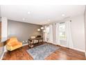 Inviting living room area with hardwood floors, recessed lighting, and large windows at 6379 Fairfield St, Whitestown, IN 46075