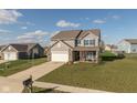 Aerial view of a two-story home featuring a basketball hoop, brick accents, and a well-maintained front yard at 6476 W Mulberry Way, Greenfield, IN 46140
