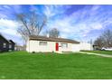 Single-story home with well-kept lawn, attached garage, and tidy landscaping under a bright sky at 676 Nelson Dr, Mooresville, IN 46158
