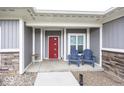 Inviting front porch with two blue Adirondack chairs and a red front door at 694 N Sobota Way, Trafalgar, IN 46181