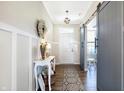 Inviting foyer with wood floors, white wainscoting and charming decorative accents at 7251 Birch Leaf Dr, Indianapolis, IN 46259