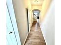 Bright hallway with wood floors leading to stairs and living area at 8030 Windham Lake Way, Indianapolis, IN 46214