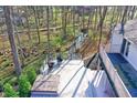 Inviting deck with a hot tub, egg chairs, and a view of the creek at 8990 Pickwick Dr, Indianapolis, IN 46260