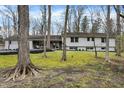 Ranch home with a front yard adorned with mature trees at 8990 Pickwick Dr, Indianapolis, IN 46260