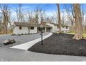 Stylish home with a well-manicured yard and walkway leading to the entrance at 8990 Pickwick Dr, Indianapolis, IN 46260