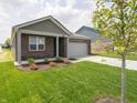 A charming single-story brick home with an attached two-car garage and manicured lawn at 915 Saddlebrook Farms Blvd, Whiteland, IN 46184