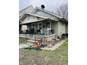 Front yard showing a small one story home with a covered porch at 918 N Olney St, Indianapolis, IN 46201