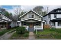Charming two-story home features a well-maintained lawn and a welcoming front porch at 926 N Dearborn St, Indianapolis, IN 46201