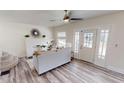 Spacious living room with a ceiling fan, natural light, and hardwood style flooring at 926 N Dearborn St, Indianapolis, IN 46201