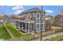 Charming two-story home features a spacious deck, fenced yard, and welcoming front porch, perfect for relaxing outdoors at 953 Harrison St, Indianapolis, IN 46202