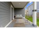 Cozy porch featuring a wicker couch and an end table perfect for relaxing at 953 Harrison St, Indianapolis, IN 46202