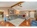 Spacious living room featuring a comfortable L shaped sofa, hardwood floors, and a vaulted ceiling at 1002 Corey Ln, Plainfield, IN 46168
