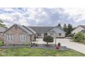 Inviting brick home with an expansive driveway and manicured landscaping at 1021 Hudson Bay Dr, Greenwood, IN 46142